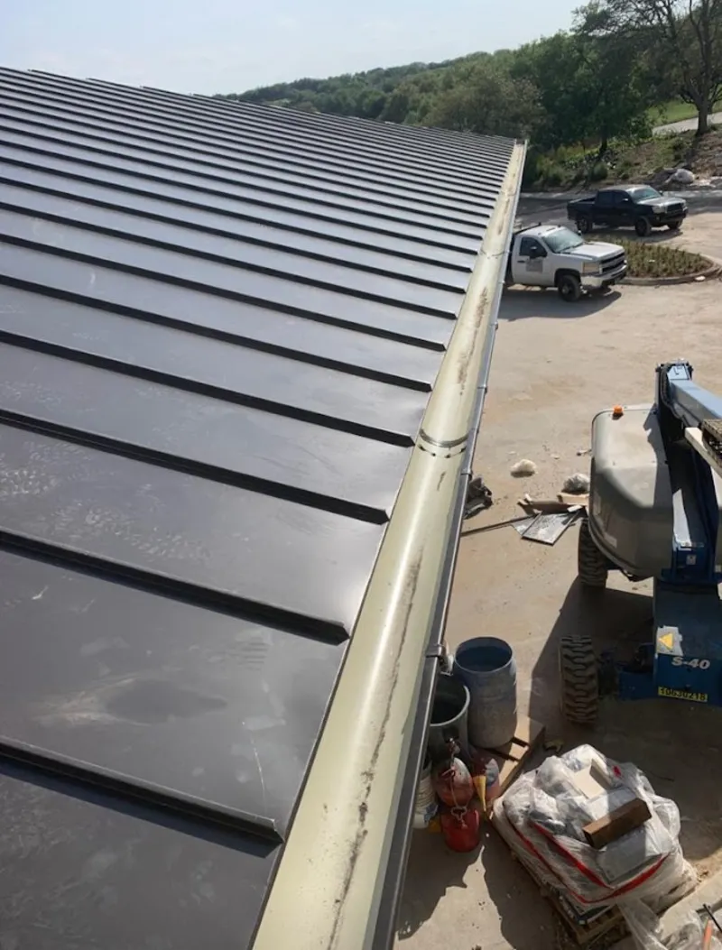 Standing seam panel and gutter detail on a metal roofing jobsite in El Dorado Hills